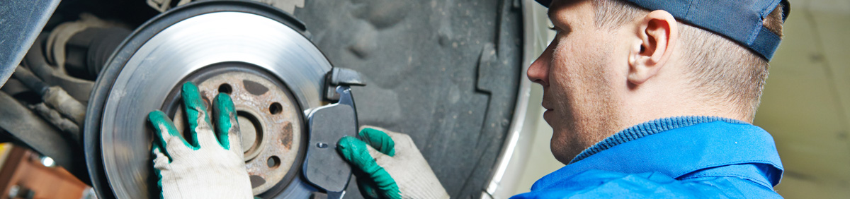 Mechanic fitting new brake pads - Car Brakes Bristol